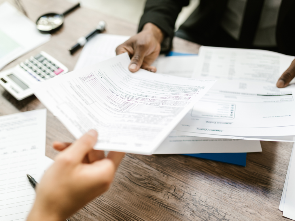 Tax and housing documents handed to a client
