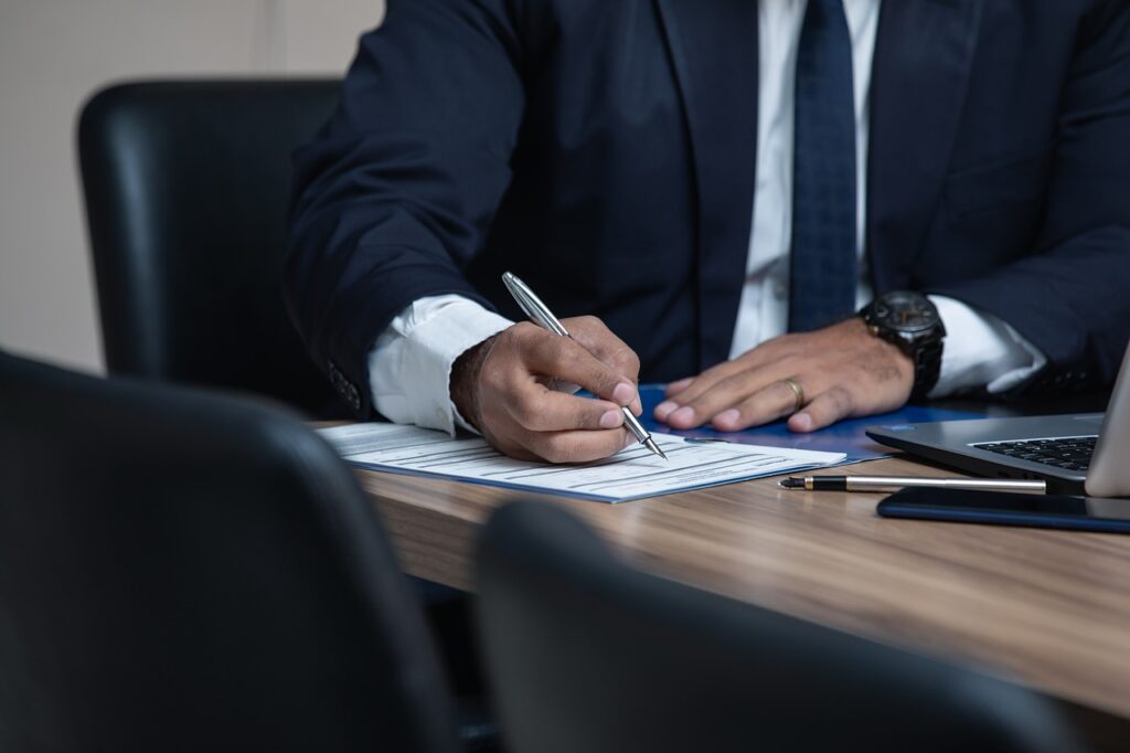 A tax lawyer signing documents