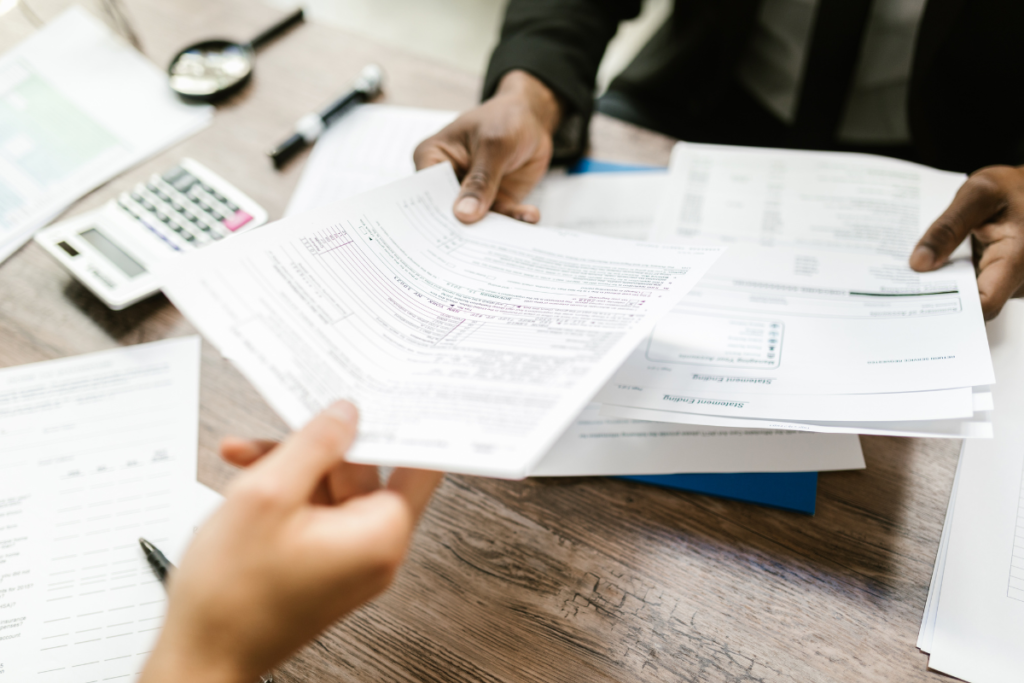 Tax lawyer handing a tax form to a client