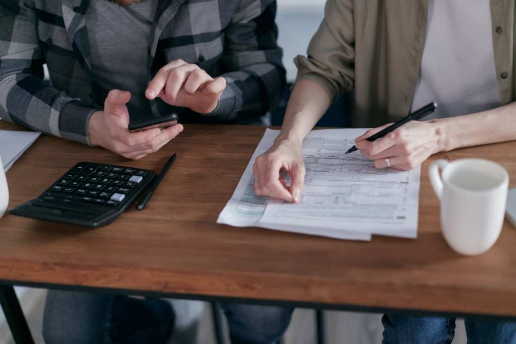 Tax attorney assisting a client with filling out tax forms
