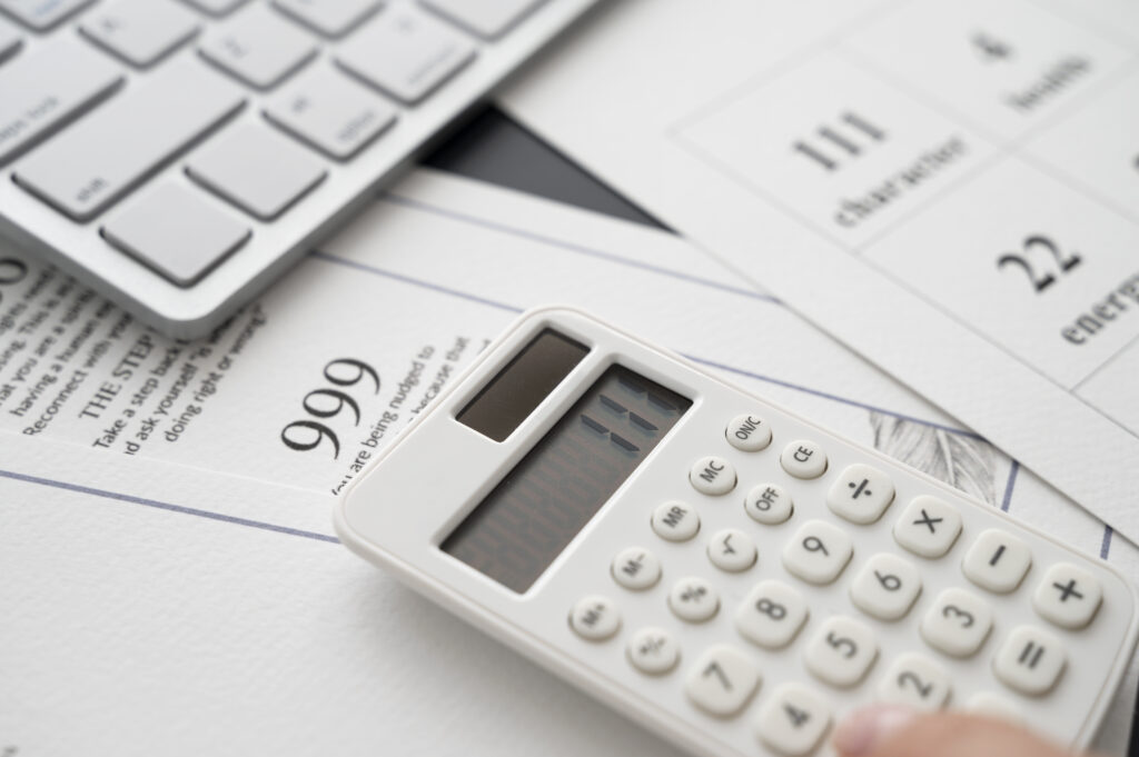 A calculator on top of tax law documents 
