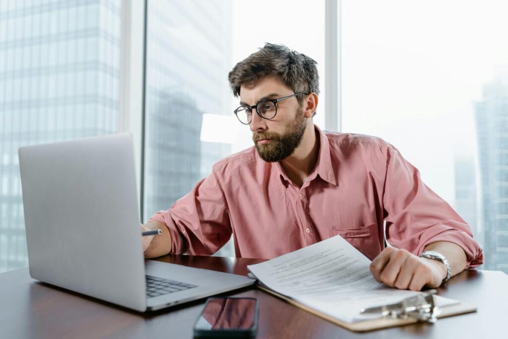 A person using a laptop for tax calculation