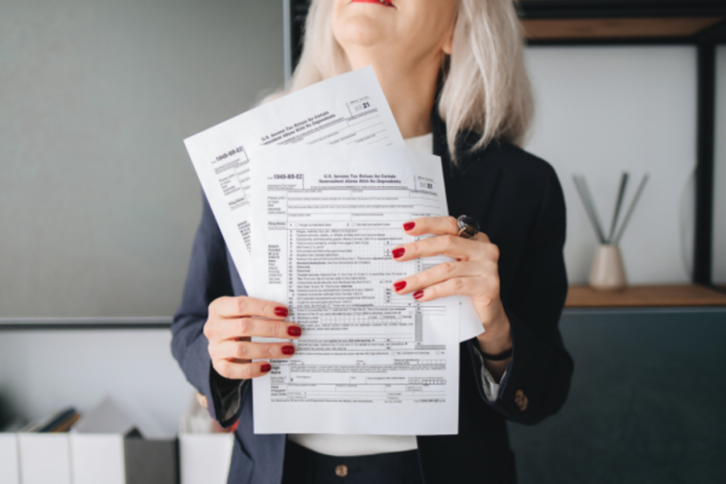 A woman holding her tax documents.