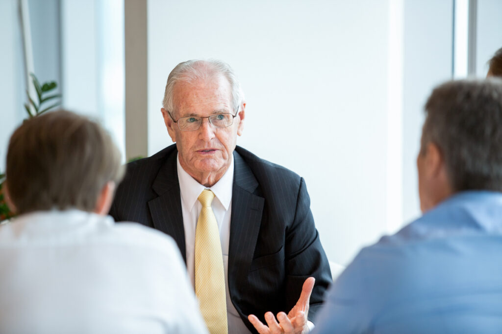 Business partners consulting a tax professional about back taxes. 