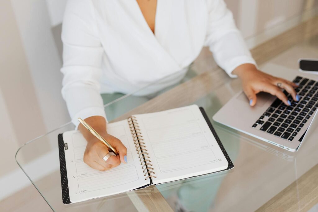 A woman with a planner scheduling the tax preparation date