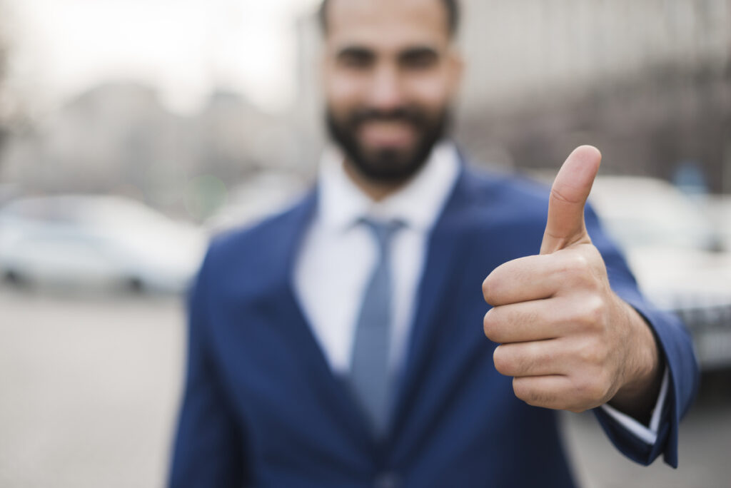 A man making a thumbs-up gesture.