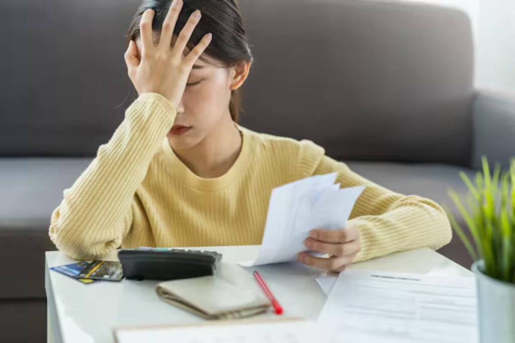 A woman stressed out over taxes, wrongfully burdened due to her ex-husband's faults